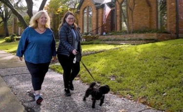 Caroline, a young adult patient, walking the dog with her mother